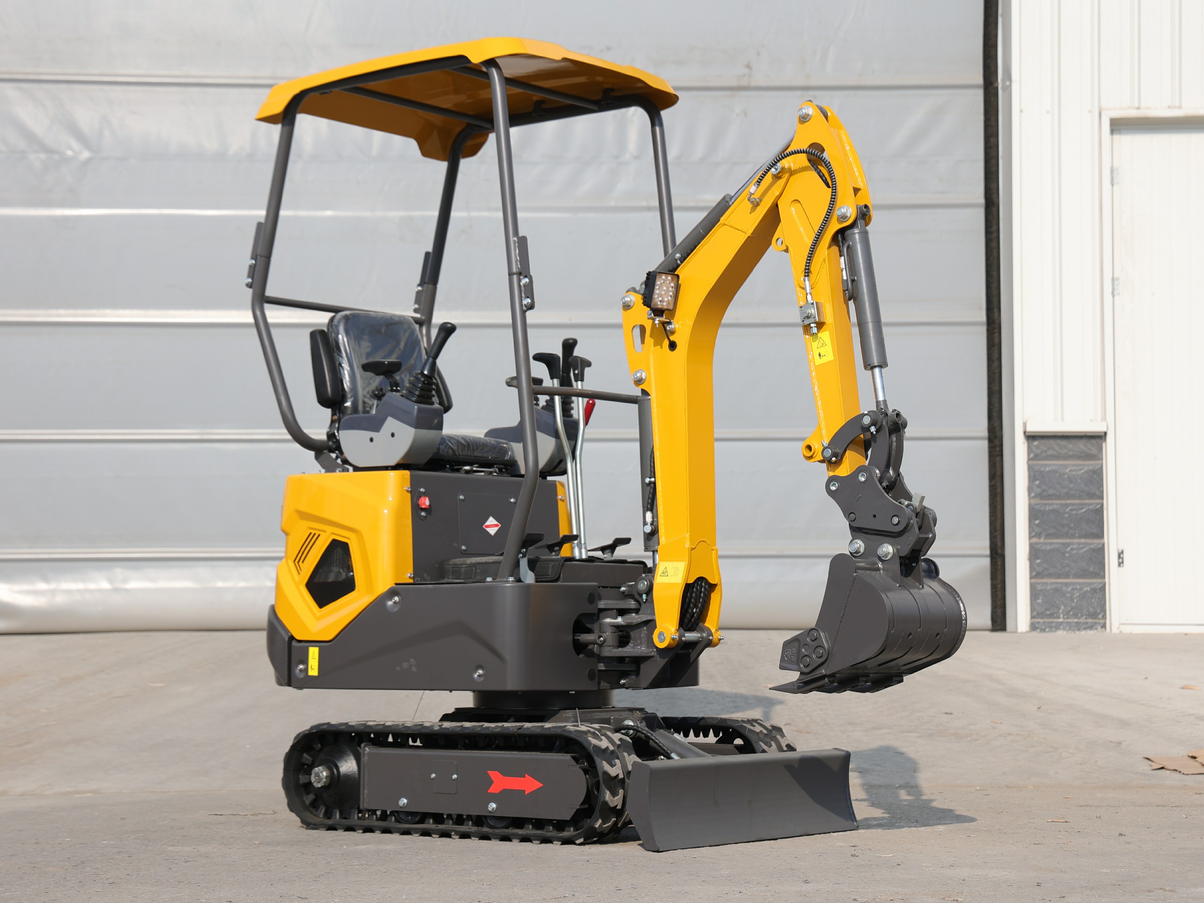 Huayee HY12 mini excavator, front-quarter view outside the Huayee facility